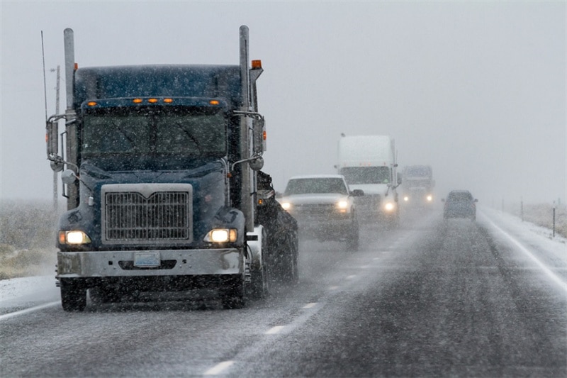Avoid driving around a large truck in icy or snowy weather